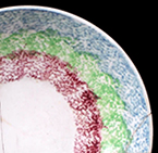 Sponged saucer showing pattern known as "rainbow" by collectors.